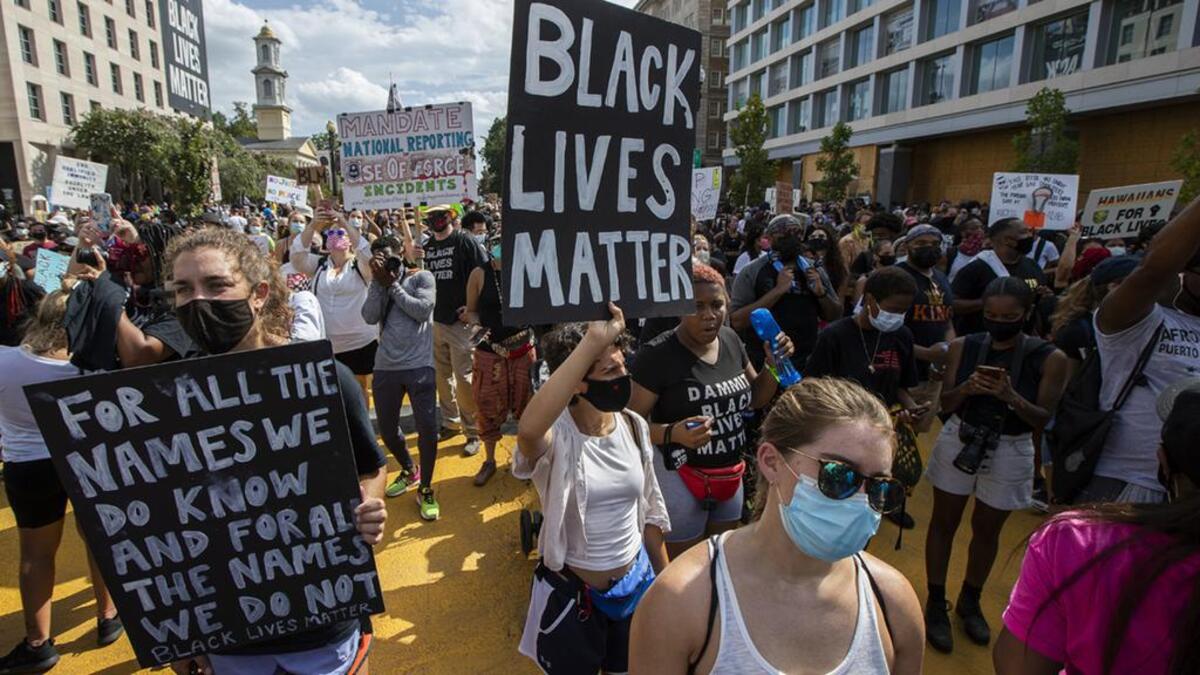 FILE - In this Aug. 28, 2020, file photo, marchers chant as they gather at Black Lives Matter Plaza near the White House in Washington, during the March on Washington commemorating the 57th anniversary of the Rev. Martin Luther King Jr.’s “I Have A Dream” speech. In the nation’s capital on Saturday, Aug. 28, 2021, multiracial coalitions of civil, human and labor rights leaders are convening rallies and marches to urge passage of federal voter protections that have been eroded since the Voting Rights Act of 1965. (AP Photo/Manuel Balce Ceneta, File)