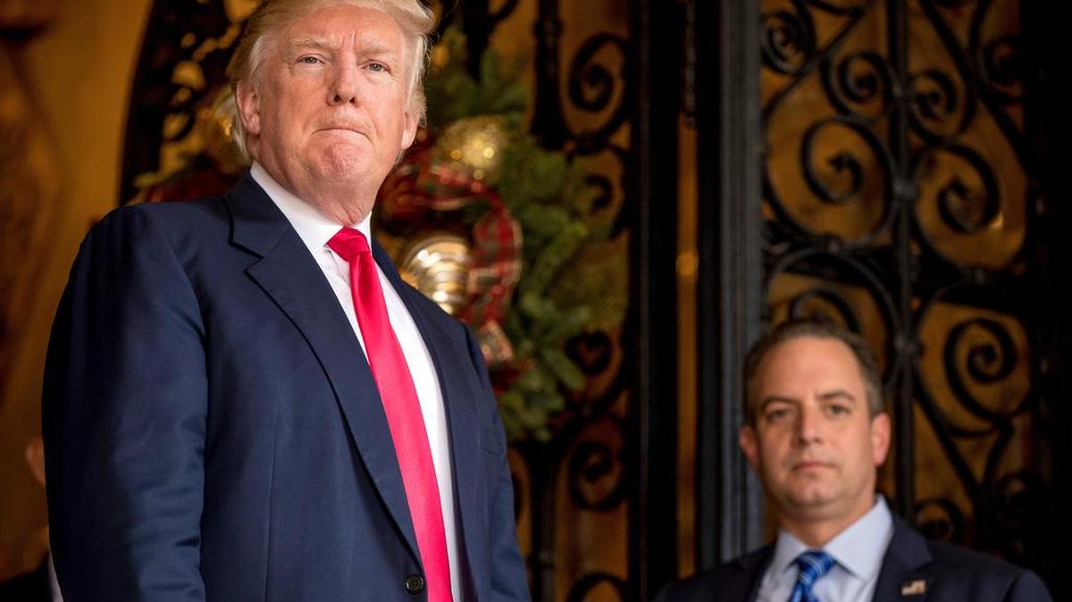 President-elect Donald Trump, left, accompanied by Trump Chief of Staff Reince Priebus, right, pauses as he takes a question from a member of the media at Mar-a-Lago, in Palm Beach, Fla..