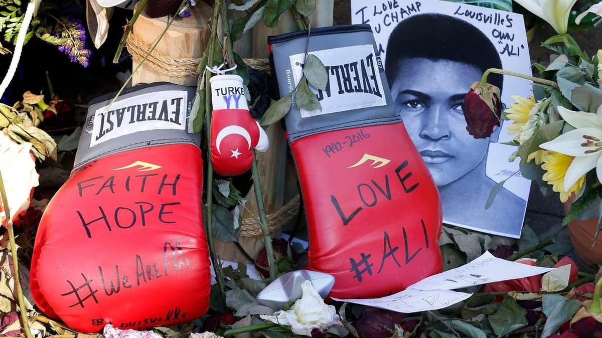 Boxing gloves left at the makeshift memorial at the Muhammed Ali Center in downtown Louisville, Ky., on Friday, June 10, 2016. Ali, a three-time world heavyweight champion, died June 3, 2016, at 74.