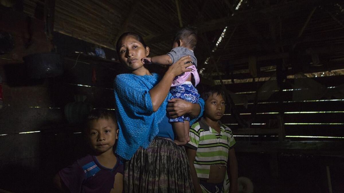 Claudia Maquin, 27, answers questions from journalists with her three children, Elvis Radamel Aquiles Caal Maquin, 5, left, Angela Surely Mariela Caal Maquin, 6 months, middle, and Abdel Johnatan Domingo Caal Maquin, 9, right, in Raxruha, Guatemala, on Saturday, Dec. 15, 2018. Claudia Maquin's daughter, 7-year old Jakelin Amei Rosmery Caal, died in a Texas hospital, two days after being taken into custody by border patrol agents in a remote stretch of New Mexico desert.