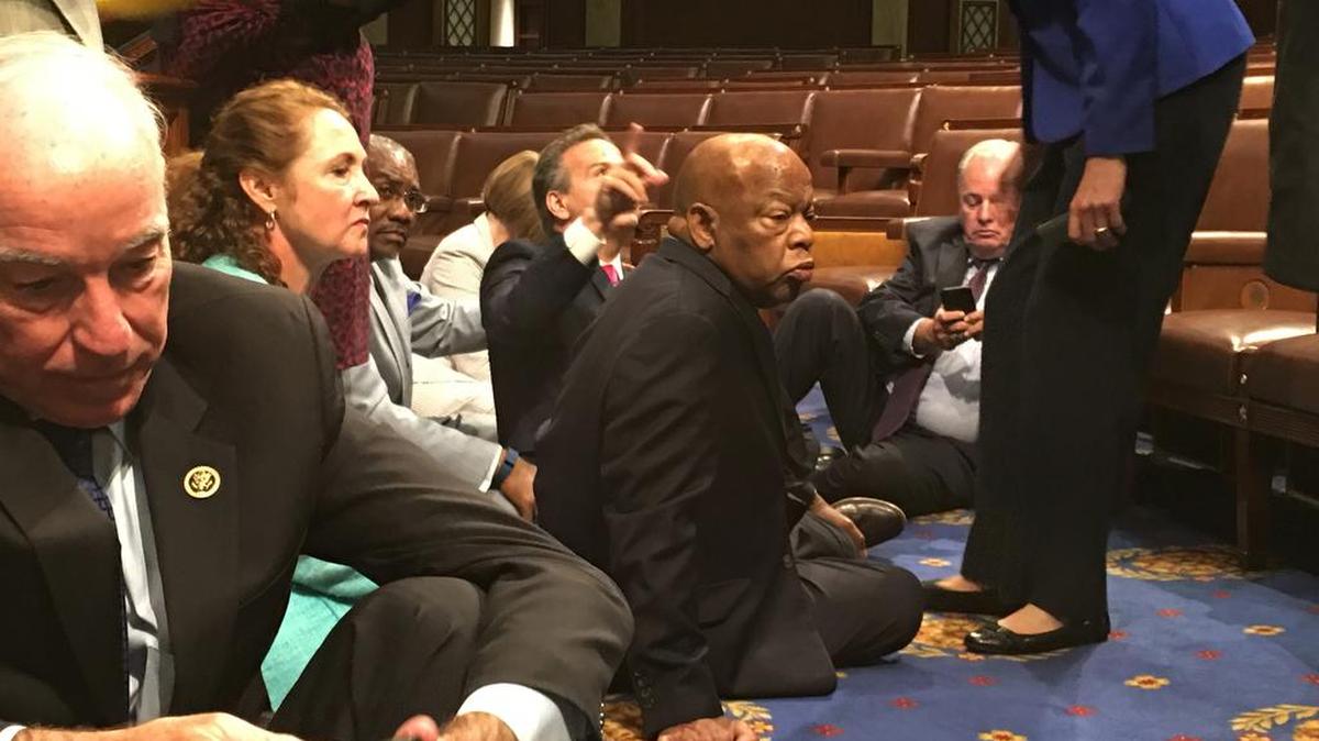 Democratic members of Congress, including Rep. John Lewis, D-Ga., center, and Rep. Joe Courtney, D-Conn., left, participate in sit-in protest on the floor of the House on Capitol Hill in Washington on Wednesday, June 22, 2016 seeking a vote on gun control measures.