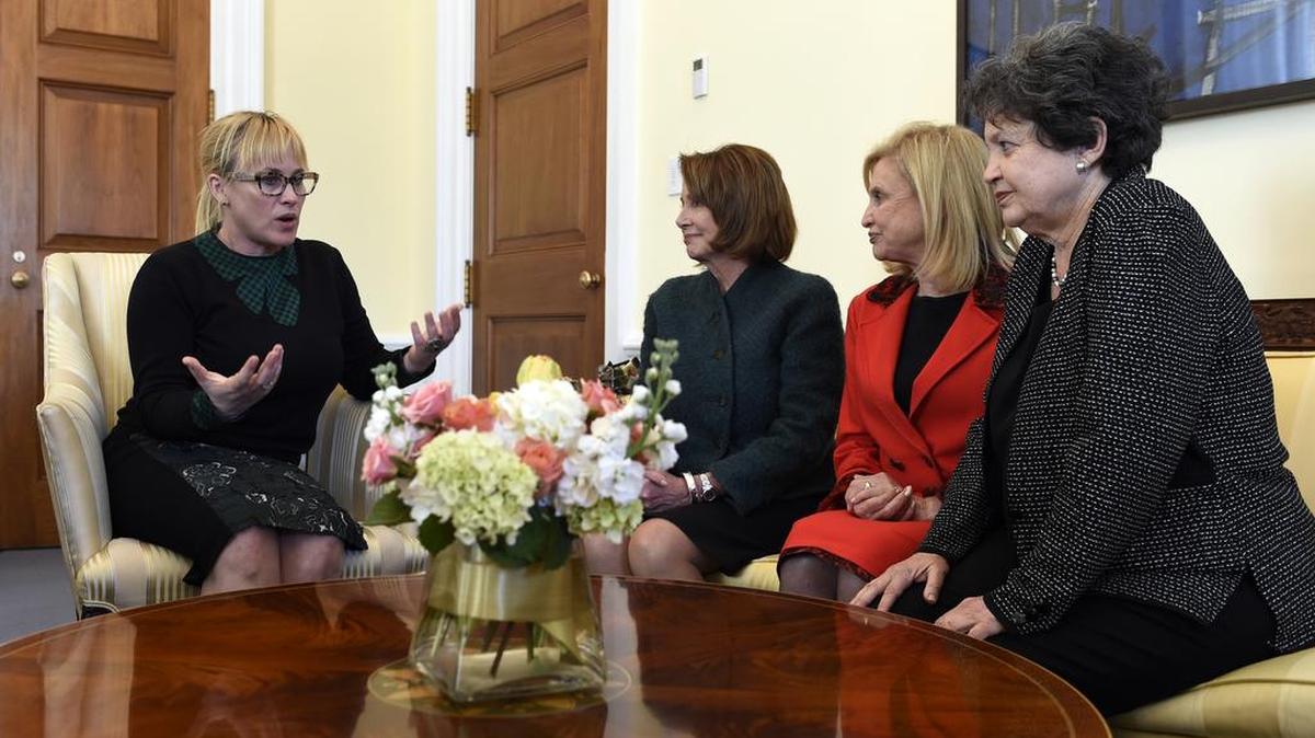Pay equity advocate Patricia Arquette, left, talks with women members of Congress.