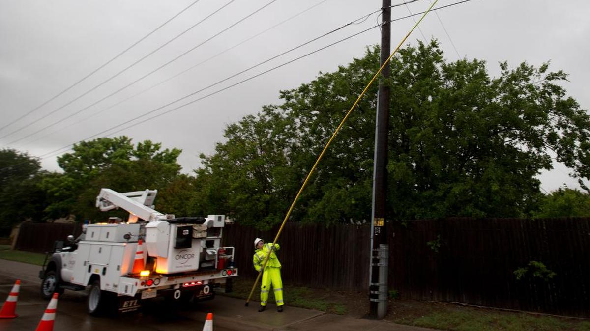 Billy Rains with Oncor replaces a line fuse on Winscott Road in Benbrook after lightning strikes interrupted power during the rain storm last year.