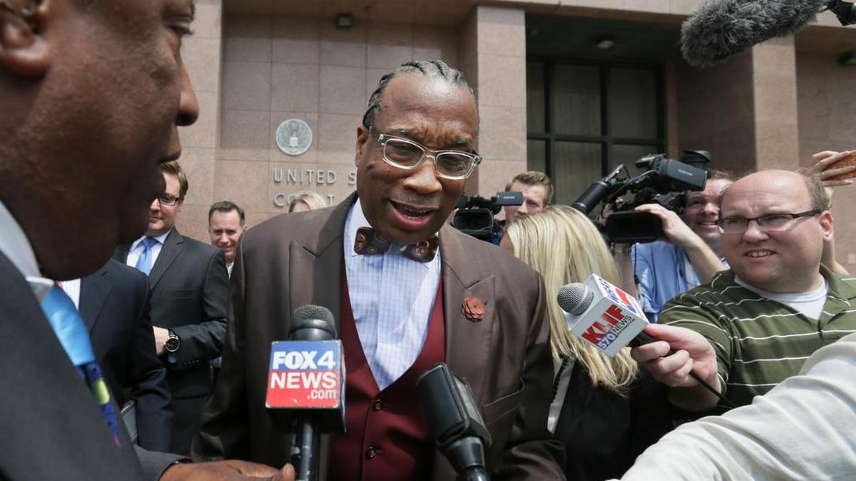 Reporters try to interview Dallas County Commissioner John Wiley Price Friday.