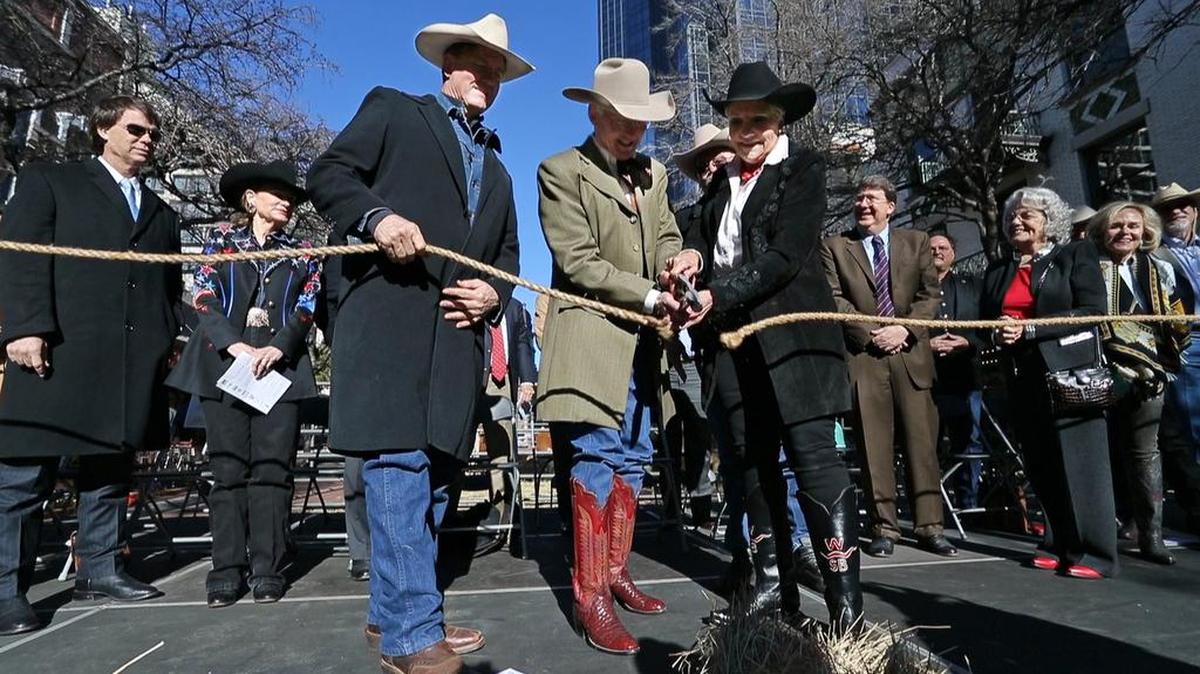 Lonesome Dove actor Barry Tubb, Ed Bass, Betsy Price and actor Barry Corbin, behind Price, cut the rope to open a museum exhibit amid the Lonesome Dove Trailhead "Rope" Cutting ceremony at the Sid Richardson Museum in Fort Worth, Texas's Sundance Square, Friday, Jan. 15, 2016. The event kicks off a six-month city-wide celebration of author Larry McMurtry's novel, which came out 30 years ago this year, and the subsequent miniseries.