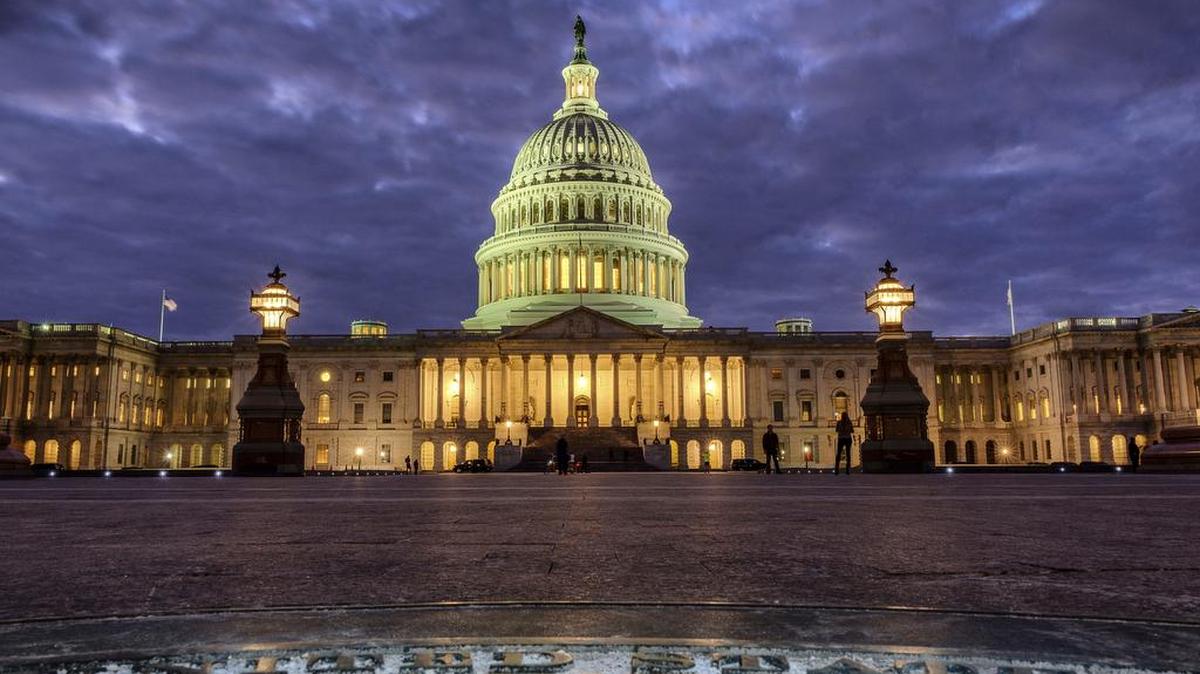 In this Jan. 21, 2018, photo, lights shine inside the U.S. Capitol Building as night falls in Washington. President Donald Trump will deliver his first State of the Union address Tuesday night.