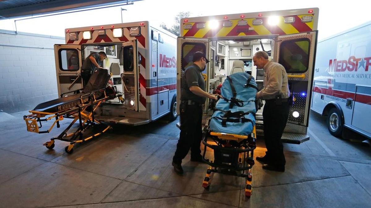Medics re-stocking ambualnces after runs at the John Peter Smith Hospital Emergency Room ambulance entrance.