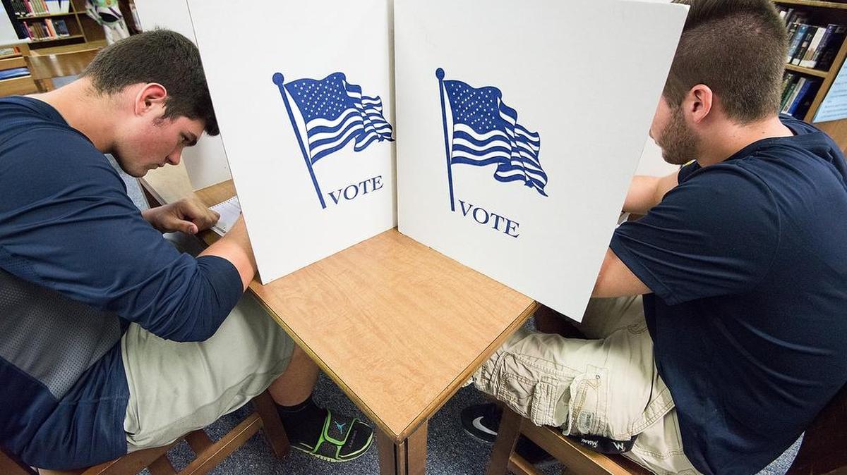 Two Virginia high school seniors, Jared Morris, left, and Nathan Rebich, vote in a mock election in Penn Laird, Va.
