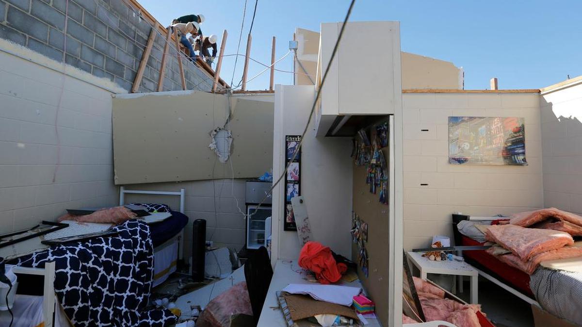 Roofers begin to make repairs after 2014 storms in Arlington. Bills pending in the Texas Legislature change some laws governing damage claims.