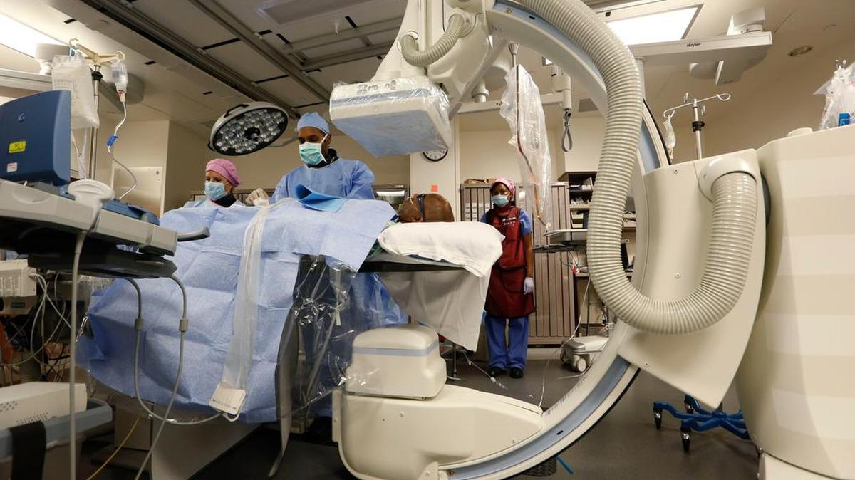 Dr. Darren Kumar, center, performs a heart catheterization procedure at the new Heart and Vascular Invasive Care Center at JPS Health Network Patient Care Pavilion.
