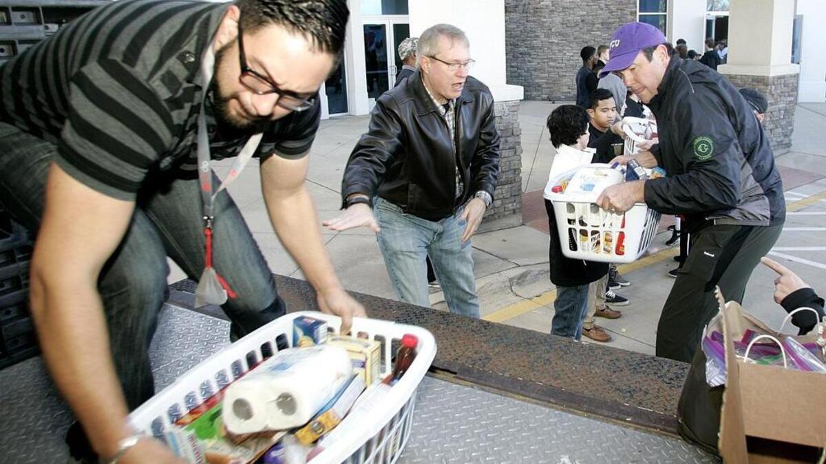 Volunteers load baskets for needy families at St. Johns Baptist Church in Southlake on Saturday.