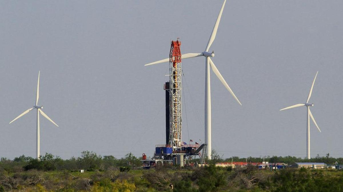 A oil well being drilled in the middle of a wind farm in Nolan County, near Sweetwater, in 2012.