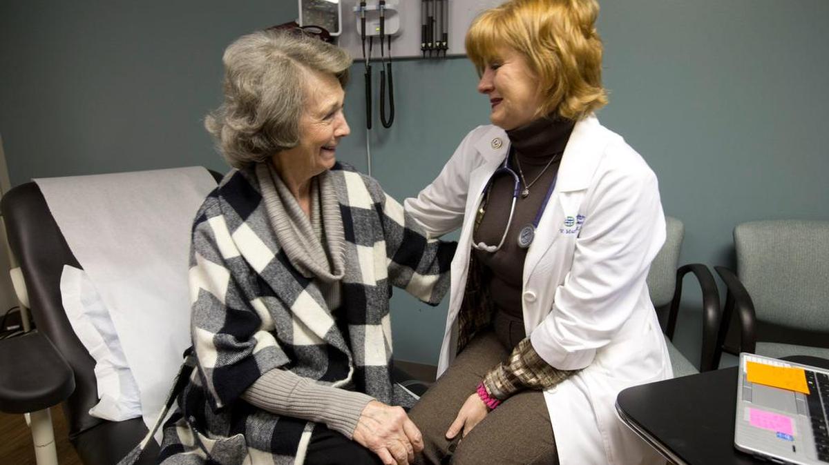 Adult gerontology primary care nurse practitioner Vanessa Murphy, right, meets with patient Phyllis Truitt in Arlington.