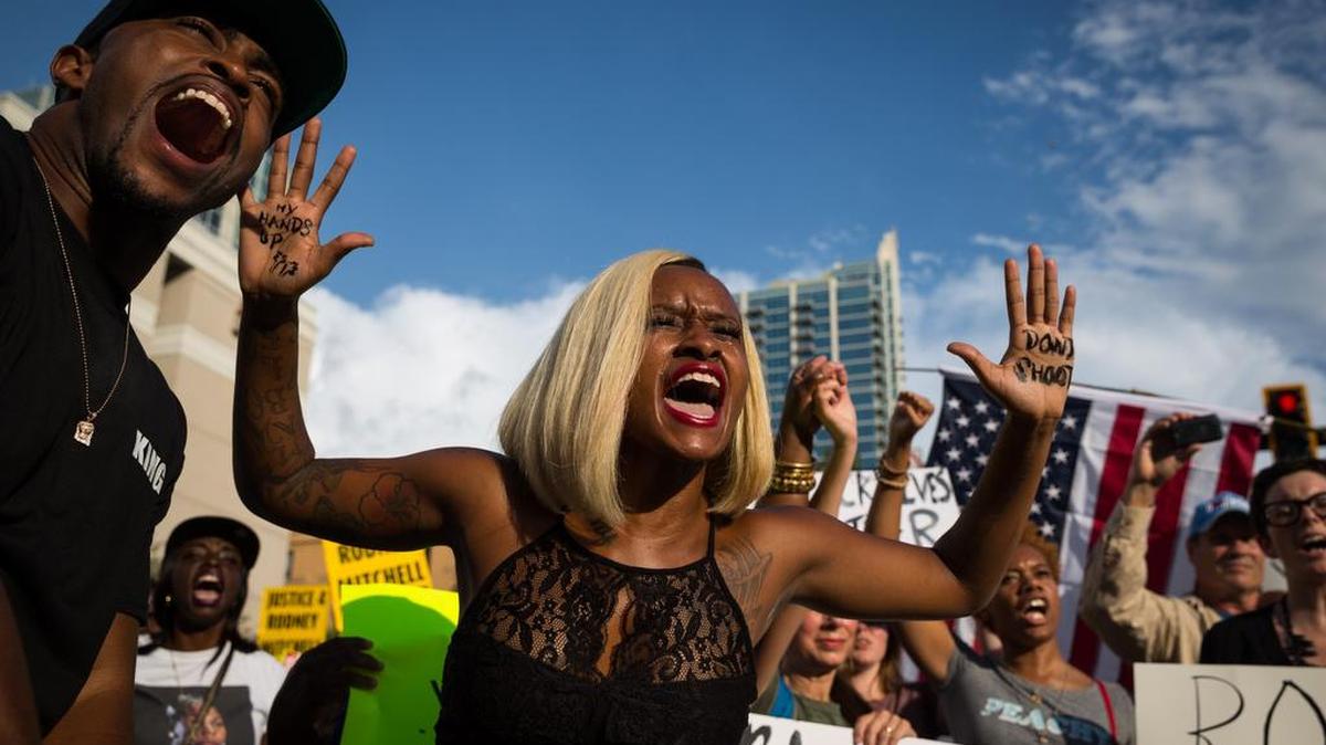Loneisha Marchman, center, and Curtis Sails, left, participate in a Black Lives Matter protest, held in response to the deaths of Alton Sterling and Philando Castile, in downtown Tampa on Monday. Sterling and Castile were shot by police officers last week.