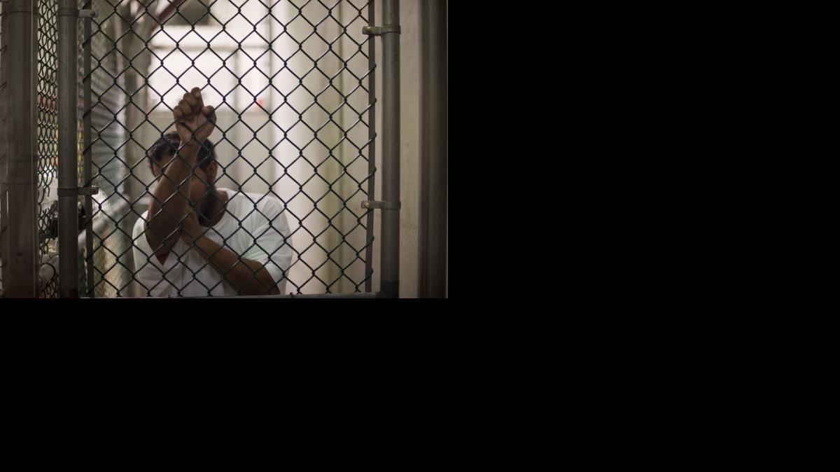 
A detainee waits to talk to a guard at the Guantanamo Bay Naval Station in Cuba. 
