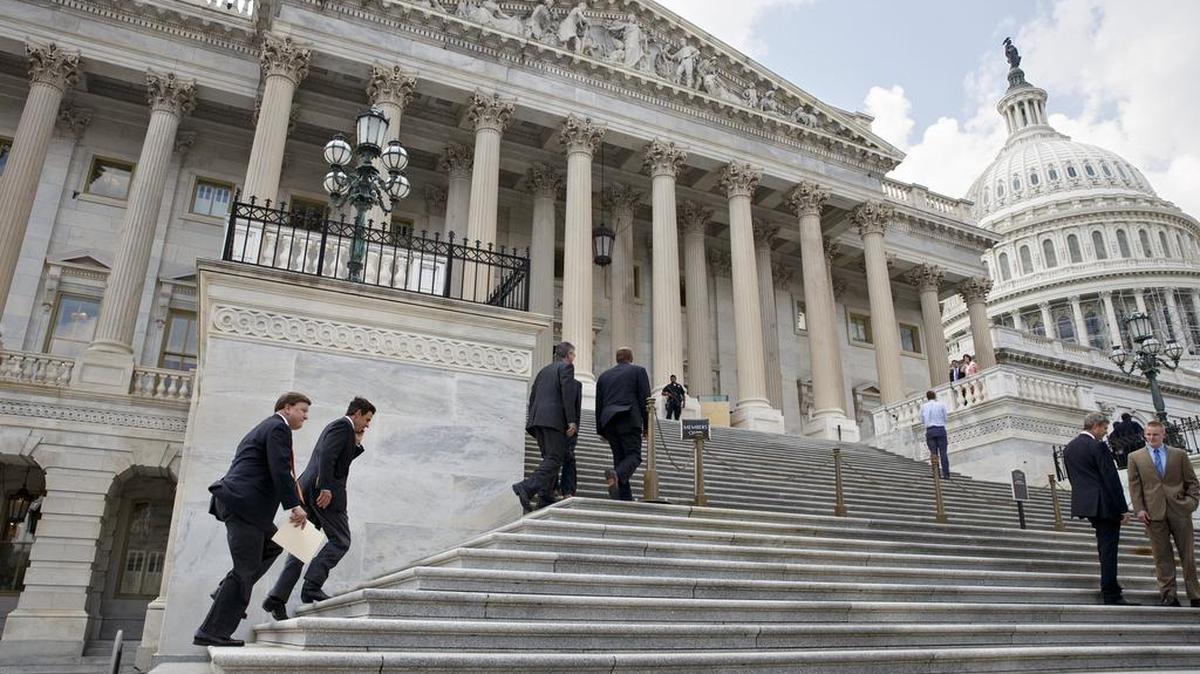 Members of Congress as climb the steps of the House of Representatives on Capitol Hill in Washington.