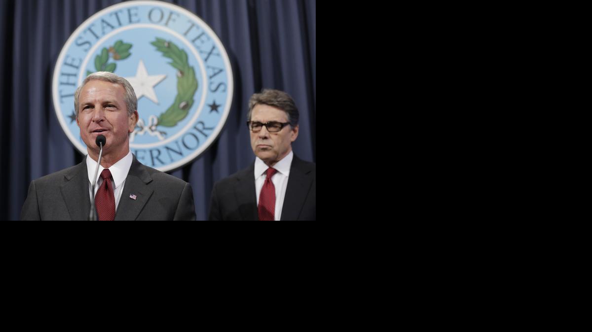 
HHS reorganization would strengthen the role of Executive Commissioner Kyle Janek, left, shown with Gov. Rick Perry in October. 
