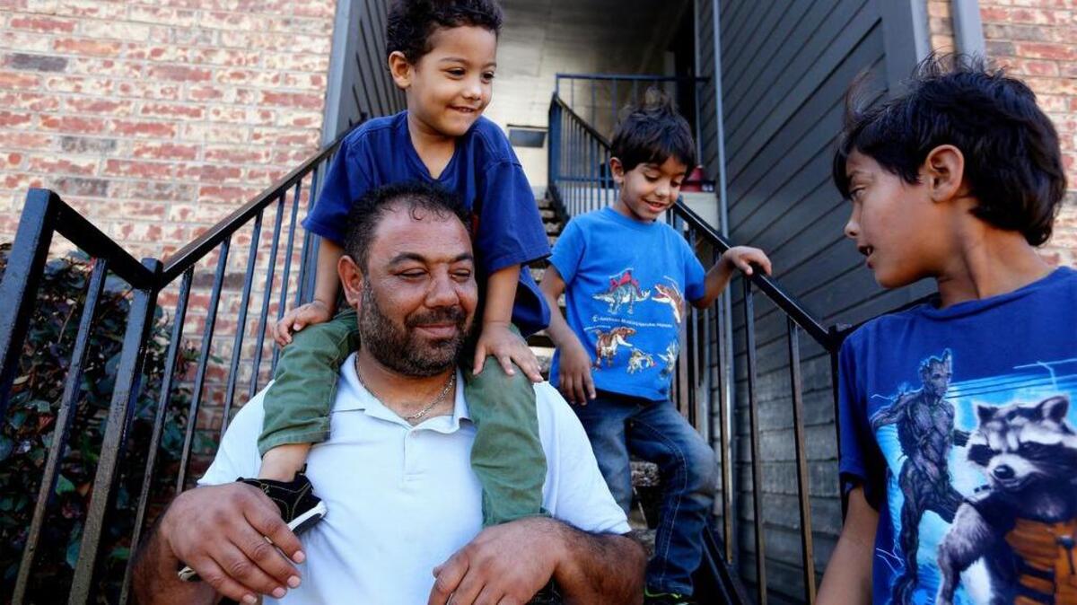 Mohammad Afshoun, 40, of Daraa, Syria, with children Reyad, 3, left, Yahia, 4, and Yousef, 7, outside their Fort Worth home early this year.