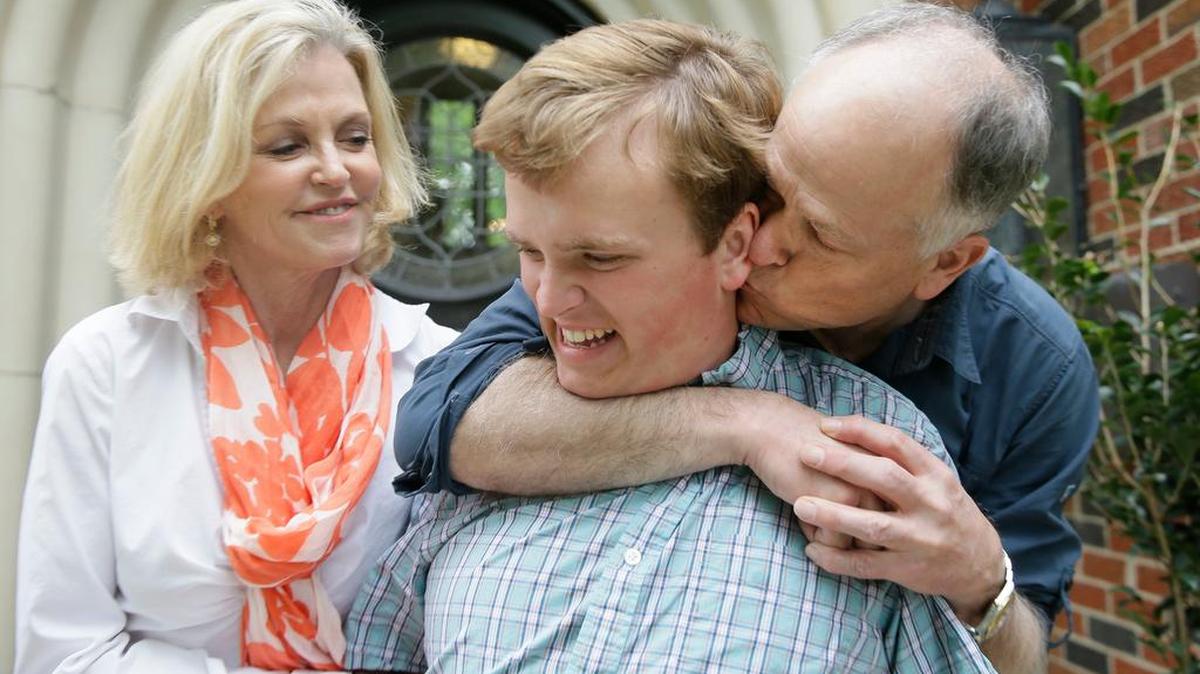 Clay Heighten, right, and Debra Caudy, left, embrace their autistic 19-year-old son Jon Heighten at their Dallas home.