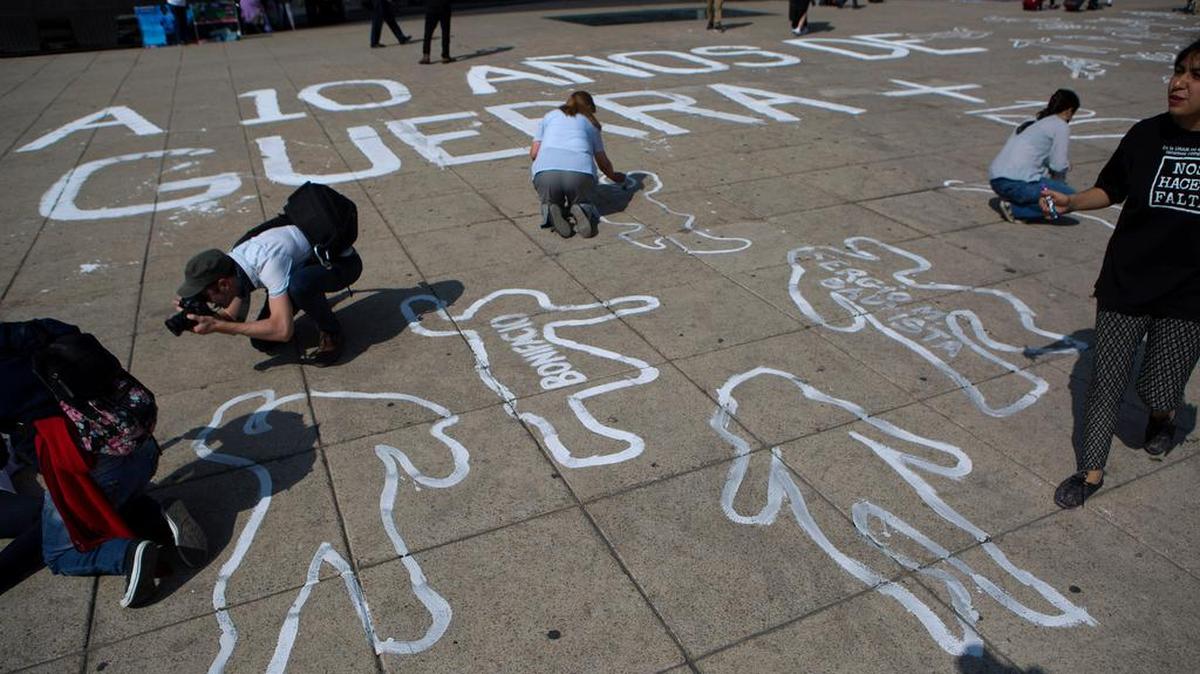 On Dec. 11, the 10th anniversary of the start of Mexico’s drug war, people painted outlines of bodies at the Monument for the the Mexican Revolution in Mexico City as part of a memorial for those killed.