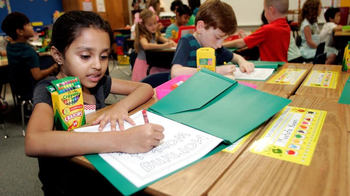 Prisha Patel, 6, colors in her binder Aug. 22 for the first day of school at Jack D. Johnson Elementary in Southlake.