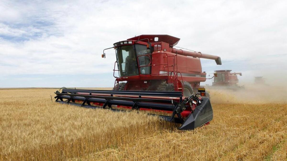 Combines harvest wheat near Roggen, Colo. Farmers and the poor benefit from subsidies in the Farm Bill, but so do other groups.