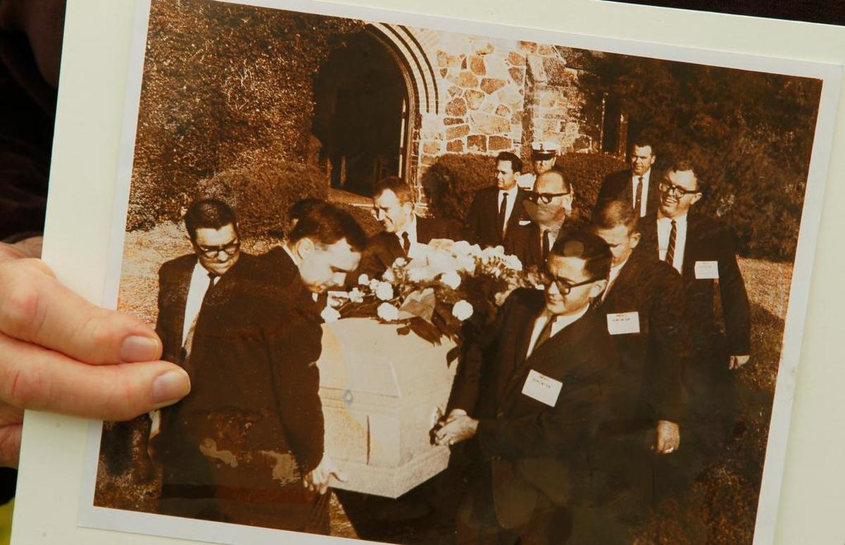 In 2013, former Associated Press and Star-Telegram reporter Mike Cochran holds a picture taken when he and other reporters were drafted to be the pall bearers for Lee Harvey Oswald because no one else was available at Rose Hill Cemetery (now Shannon Rose Hill) where accused Kennedy assassin Lee Harvey Oswald was buried after he was shot by Jack Ruby.
