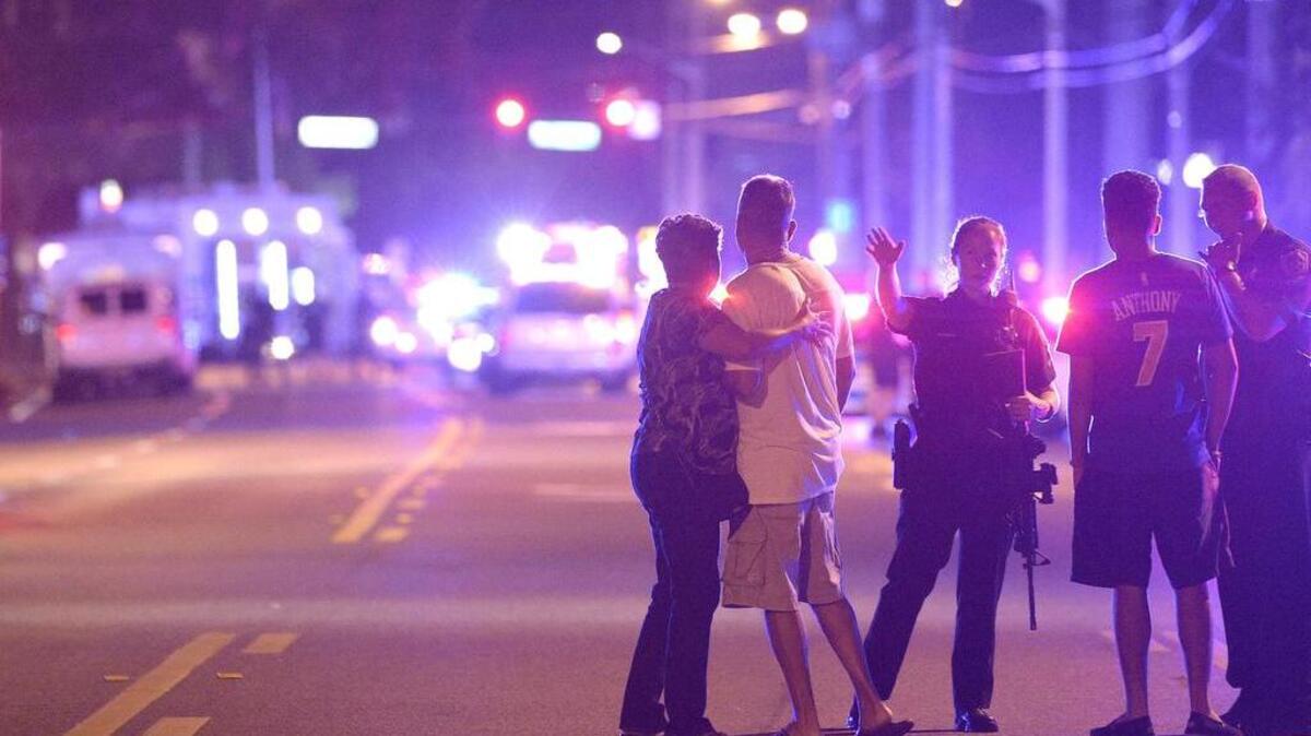 Orlando police direct family members away from the Pulse nightclub June 12.
