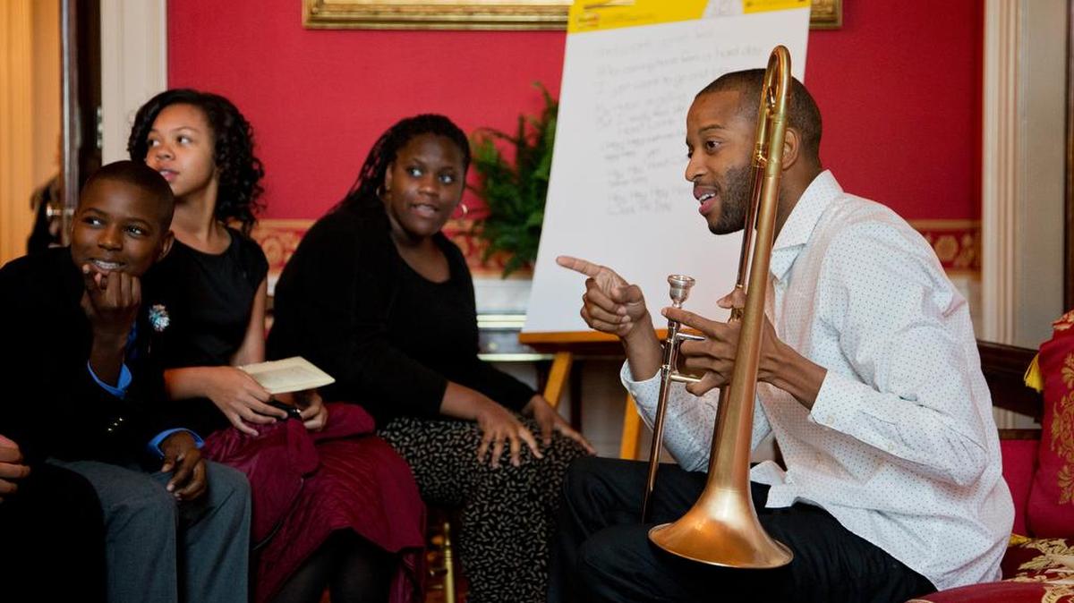 New Orleans musician Trombone Shorty, right, mentors a group of middle school students from the Washington area during a 2015 interactive student workshop at the White House.
