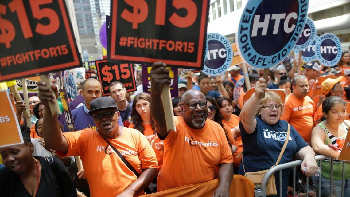 In July 22, 2015, file photo, activists cheer during a rally after the New York Wage Board endorsed a proposal to set a $15 minimum wage for workers at fast-food restaurants with 30 or more locations in New York.