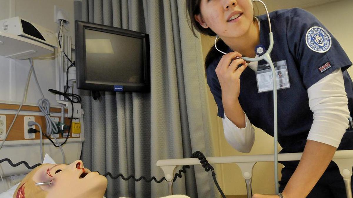 A nursing student works with an interactive patient simulator at the University of Texas at Arlington.