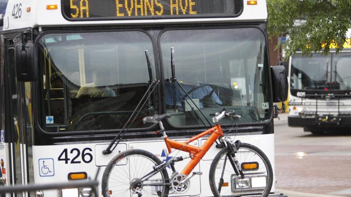 A "T" bus pulls out of the station bearing a bike as cyclists and public transportation officials gathered downtown at The Intermodal Transit Center, despite occasional rain showers, to observe National Bike to Work day in Fort Worth, TX, Friday, May 20, 2011.