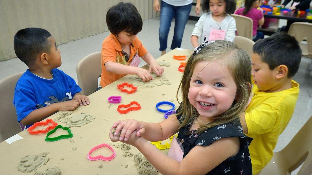 Students work with molding sand in Early Childhood Matters at Riverside Community Center in Fort Worth.