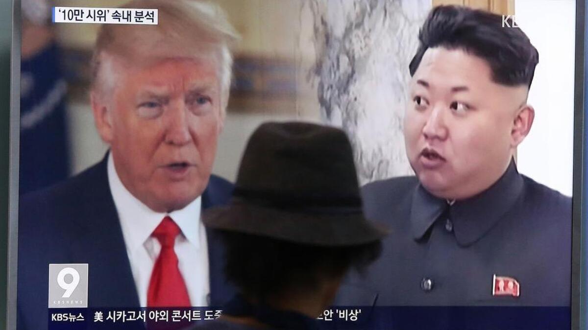 A man watches a television screen showing U.S. President Donald Trump and North Korean leader Kim Jong-un during a news program at the Seoul Train Station in Seoul, South Korea. North Korea said Monday, Sept. 11, 2017 it will make the United States pay a heavy price if a proposal Washington is backing to impose the toughest sanctions ever on Pyongyang is approved by the U.N. Security Council this week.