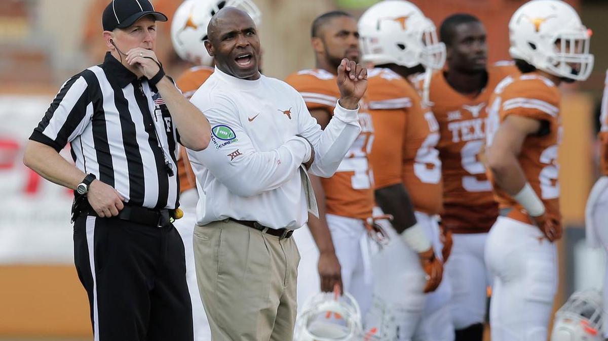 
Texas head coach Charlie Strong, center, talks to an official during a Sept. 26 game against Oklahoma State. 
