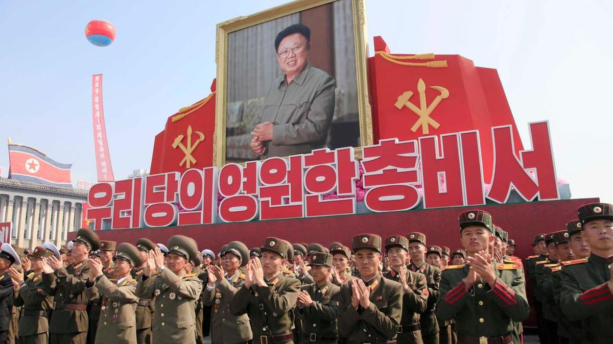 Soldiers applaud during an event marking the 20th anniversary of the election of former North Korean leader Kim Jong Il, in portrait, as general secretary of the Workers' Party, which is the founding and ruling party of North Korea, at Kim Il Sung Square in Pyongyang, Sunday, Oct. 8, 2017.