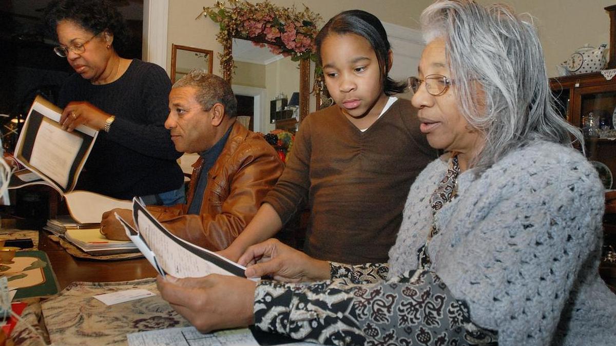 Ruth Adair Nash, a descendent of freedmen, goes over family history papers with her granddaughter Rudi Thompson at Ruth's home in Bartlesville, Okla. in 2006.