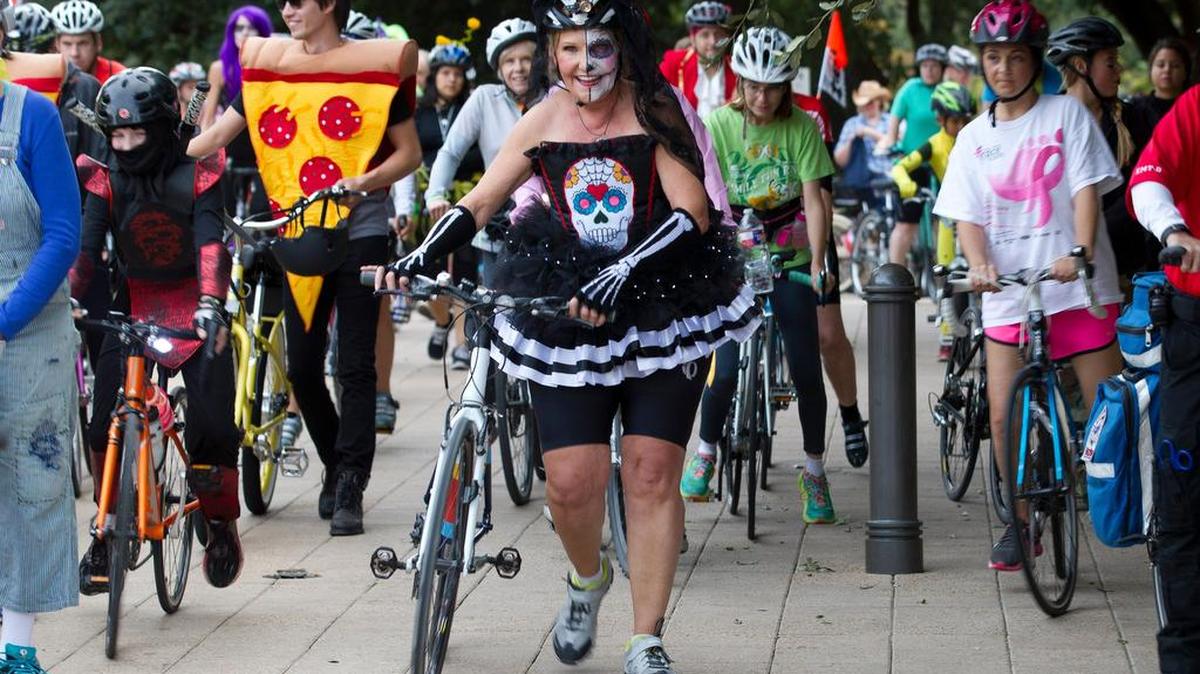 Mayor Betsy Price, center, led a costumed bike ride Oct. 28 from the Water Gardens to Pioneers Rest cemetery.