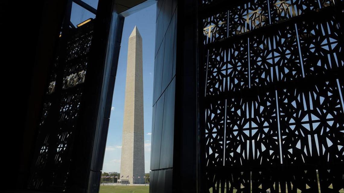 The Washington Monument is framed by a window at the National Museum of African American History and Culture in Washington, Wednesday, Sept. 14, 2016, during a press preview.
