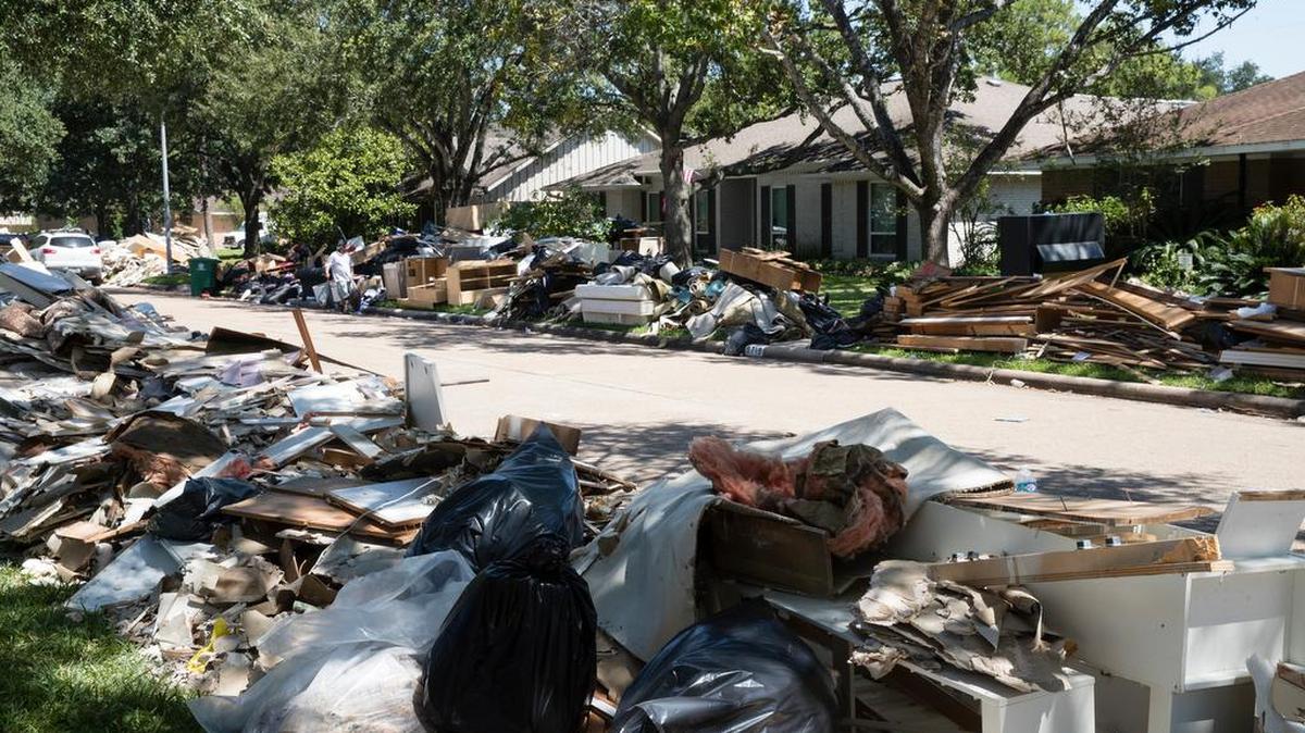 Flood damaged debris from homes lines the street in the aftermath of Hurricane Harvey on Thursday, Sept. 7, 2017, in Houston.