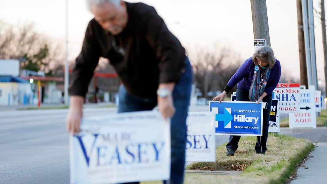 Gary Livingston for Tarrant County Democratic Party Chair, left, and Pam Durham, a Hillary for Texas Grassroots volunteer, straighten campaign signs at the Griffin Sub-Courthouse in Fort Worth, Tuesday, February 16, 2016.