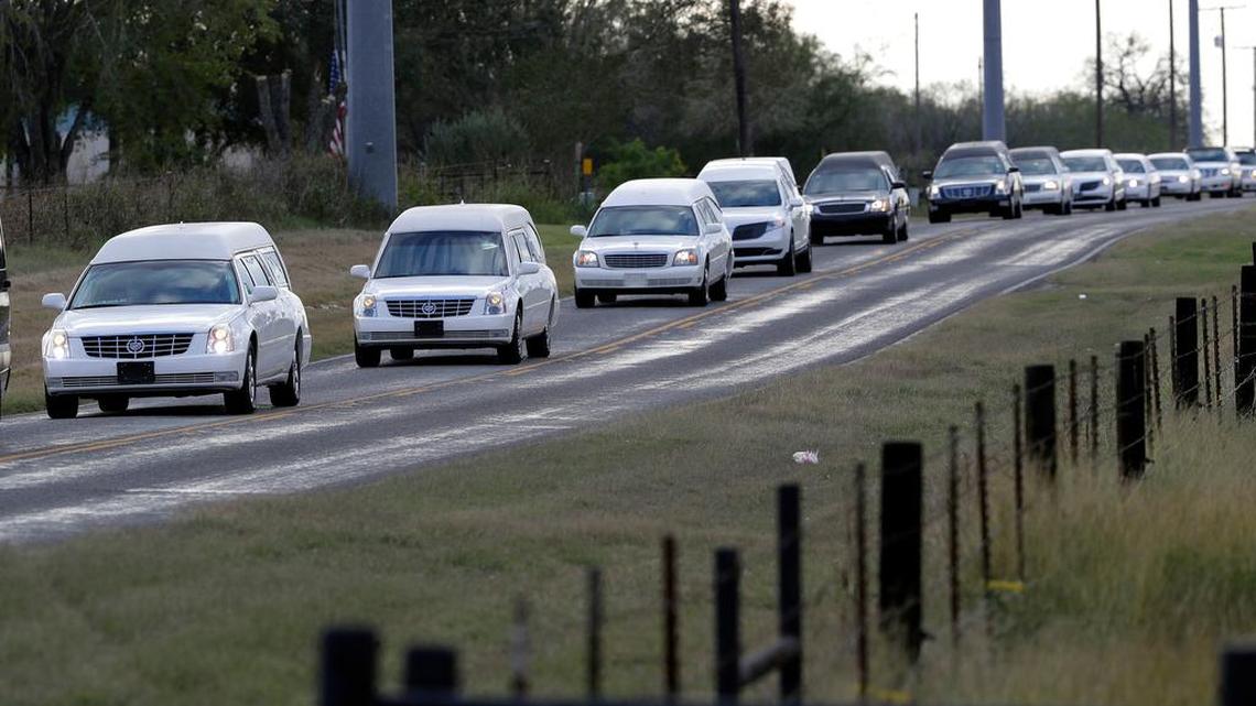 A procession of hearses pass along a country road to a graveside service for members of the Holcombe family who were killed in the Sutherland Springs Baptist Church shooting, Wednesday, Nov. 15, 2017, in Sutherland Springs, Texas. A man opened fire inside the church in the small South Texas community Sunday, Nov. 5, killing more than two dozen.