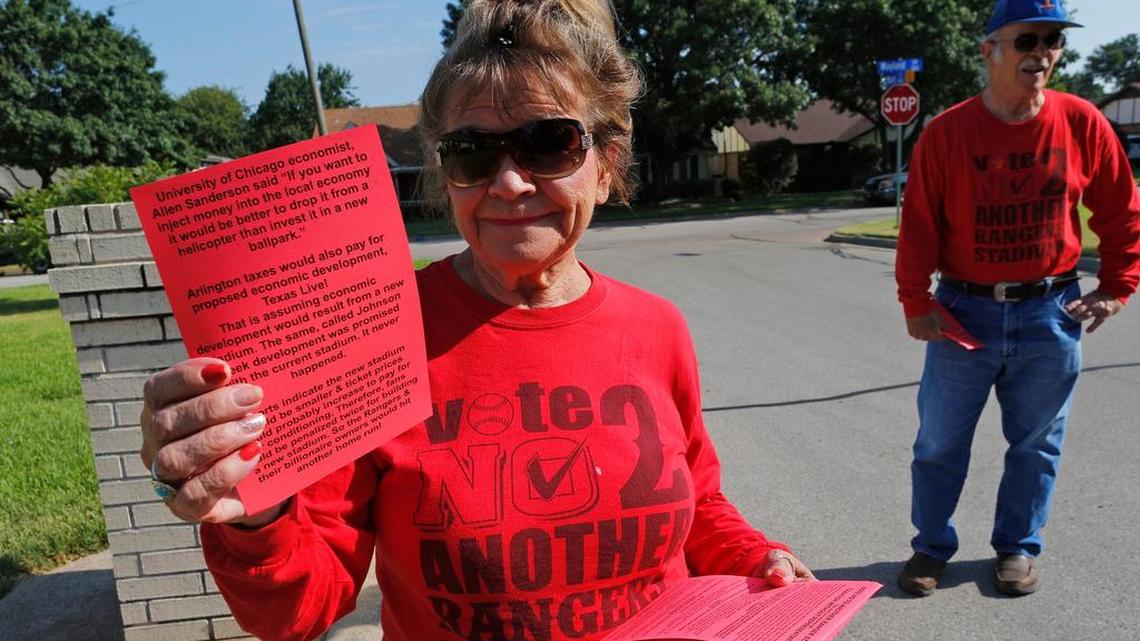 Peggy Rudd and her husband Bill Gaut pass out flyers Aug. 12 against the proposed new ballpark for the Texas Rangers in Arlington.