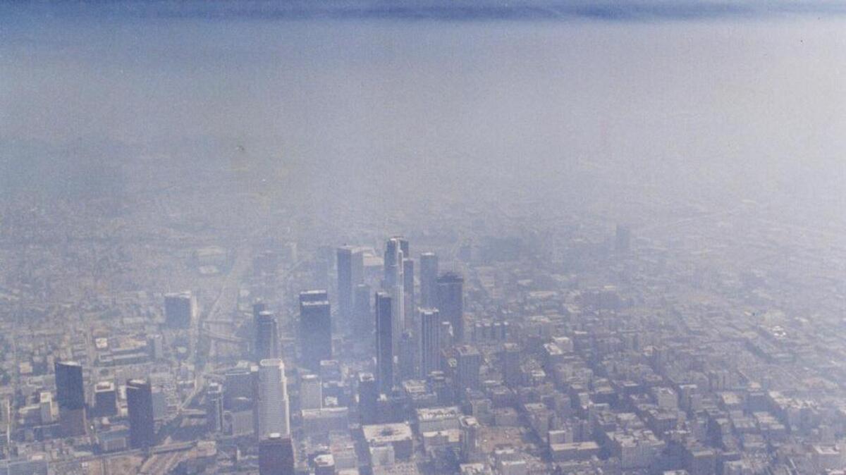 An all-too-common aerial view of the downtown Los Angeles skyline covered in smog. (Los Angeles Times)