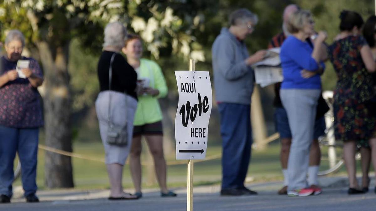 Voters stand in line to vote at an early voting polling site, Monday, Oct. 20, 2014, in San Antonio.