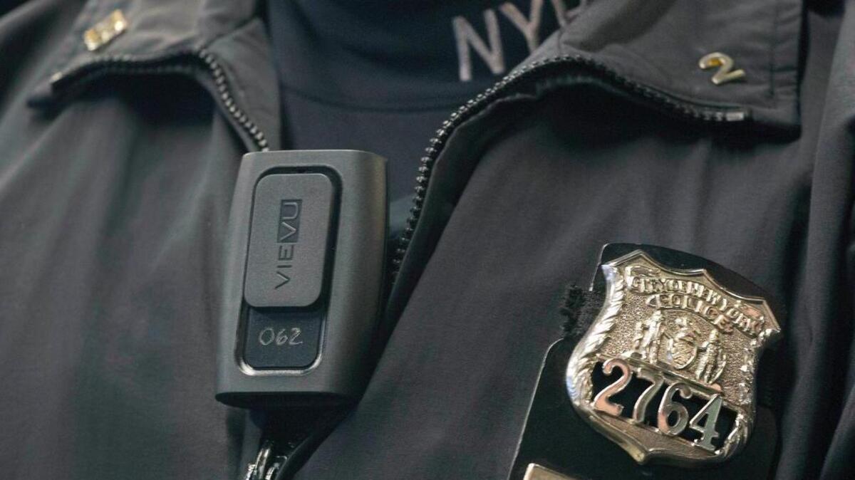 New York police officer Joshua Jones wears a VieVu body camera during a news conference in New York.