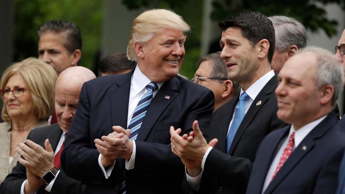 President Donald Trump talks with House Speaker Paul Ryan after the House pushed through a health care bill earlier this month.