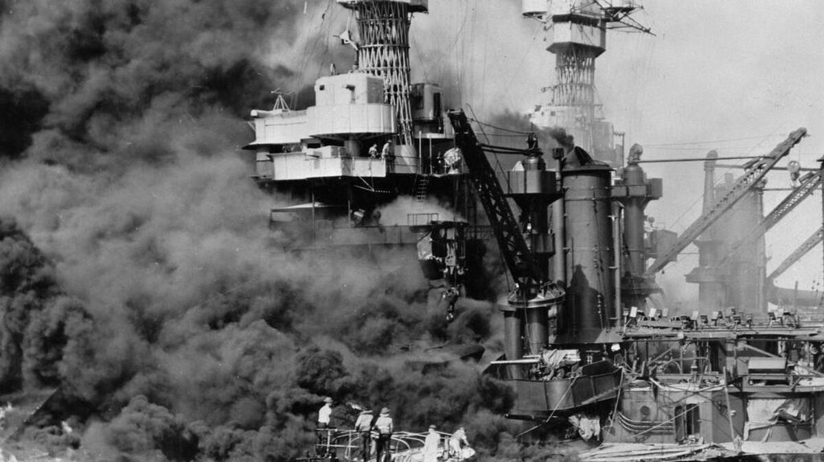 A small boat rescues a seaman from the USS West Virginia burning in Pearl Harbor, Hawaii, after Japanese aircraft attacked the military installation on Dec. 7, 1941. More than 2,300 U.S. service members and civilians were killed in the strike that brought the United States into World War II.