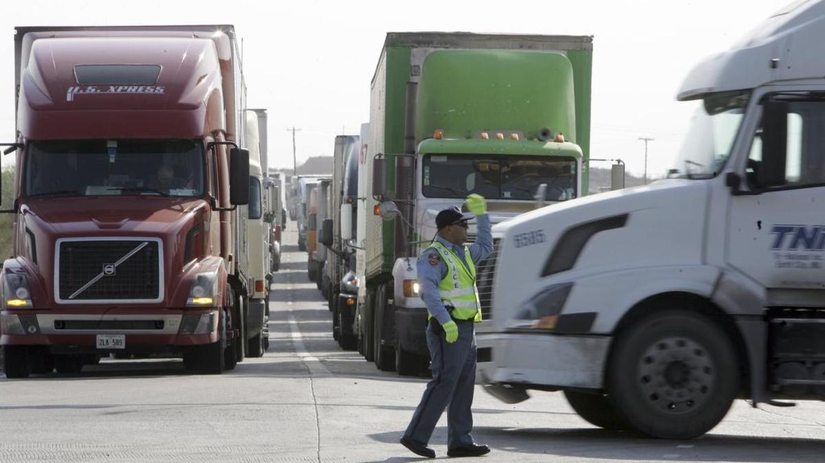 An officer directs traffic at the border in Laredo, which has benefited greatly from NAFTA.