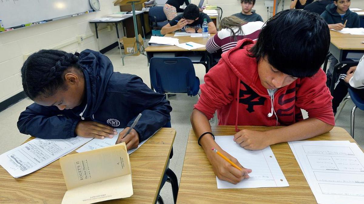 Kara Johnson-Ford, left, and Pedro Alarcon work on their assignments at Dunbar High School in Fort Worth.